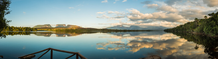 Panoramic view of sunrise over three small mountains. Canaima National Park, Venezuela