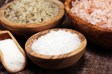 sea salt in bowl. Crystals of salt on table and himalayan salt.