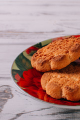 Cookies in saucer on wooden background nice