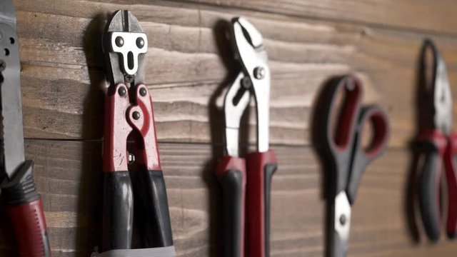 A close-up of a worker putting a craftsman hand tool on its place. Hand tools set