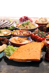 Middle eastern or arabic dishes and assorted meze, concrete rustic background. Falafel. Turkish Dessert Baklava with pistachio. Halal food. Lebanese cuisine