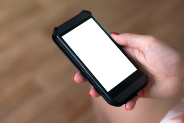 Mobile phone with blank screen in a woman hands.