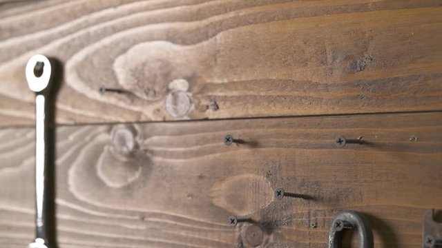 A demonstration video of a craftsman taking a hammer and putting it on its place.