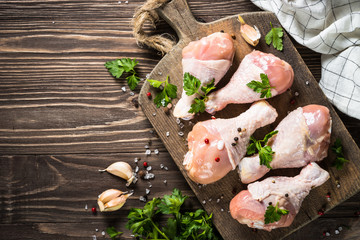 Chicken drumctick on cutting board.