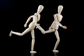 Mannequin dolls in interaction isolated on black background