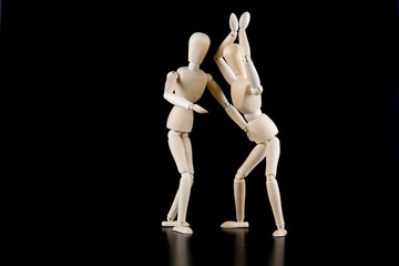 Mannequin dolls in interaction isolated on black background