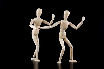 Mannequin dolls in interaction isolated on black background