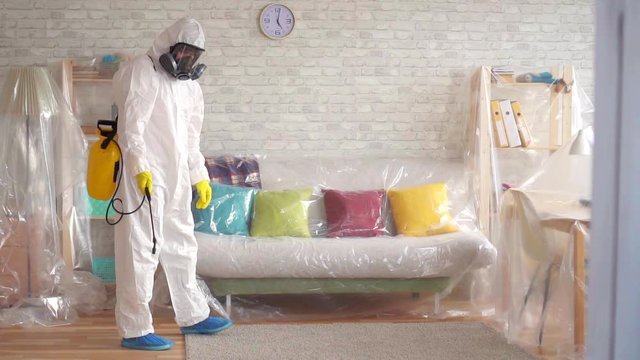 Man carries out pest control slow mo