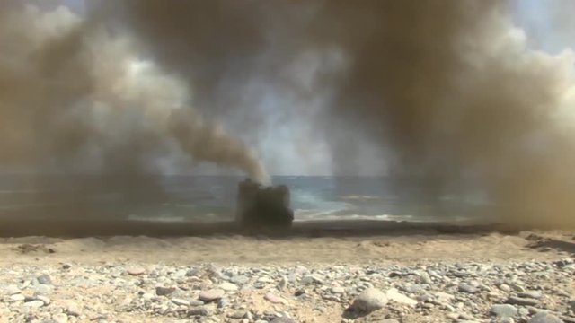 AAV 7A1 ejecting smoke from their exhaust pipe and reaching the coast