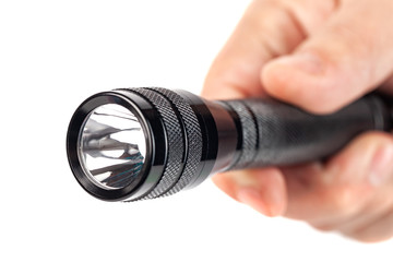 Hand holding flashlight on white background