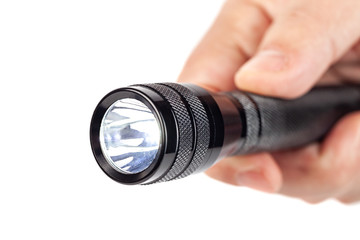 Hand holding flashlight on white background
