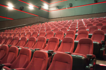 part of a theatre, or similar building, where the people who are watching and listening sit
