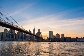 Naklejka na ściany i meble View of the Brooklyn bridge during a dusk from East river. New York City
