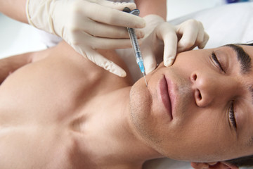 Top view man on facial beauty procedure