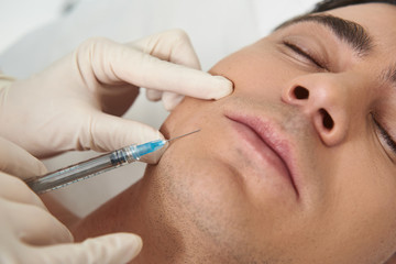 Close up man on facial beauty shot procedure