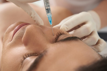 Man on anti-wrinkling procedure of under eyes