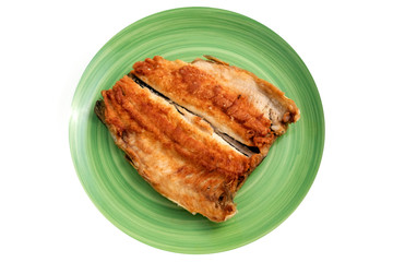 Baked fish on a plate. Golden river trout. The round green plate with the trout fillet. Seafood, their cooking concept. Isolate.