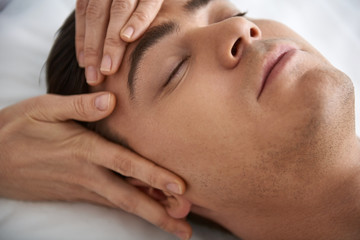 Fototapeta na wymiar Close up of lifting face massage for young man