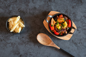 Vegetarian ratatouille with baked aubergine, zucchini, pepper in tomato sauce. Dish served with...