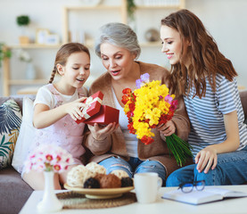 mother's day! three generations of  family mother, grandmother and daughter congratulate on the...
