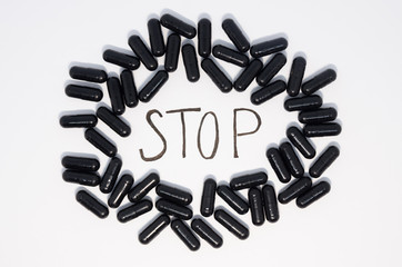 Medical black pills in a circle