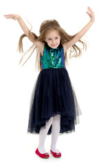 Naklejka premium A little girl fixes her hair.