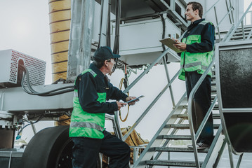Two workers from technical staff having job