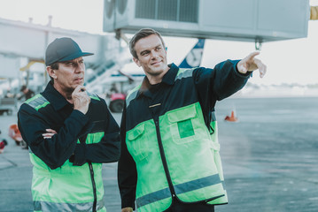 Two mechanics having conversation in the workplace