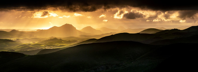 Yellow Sunlight with Silhouetted Mountains