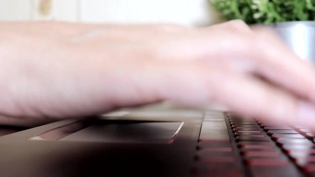 Female woman hands scrolling toucpad and typing on keyboard of laptop, no face woman sitting by the table freelancing working at home, writes post comments in social networks