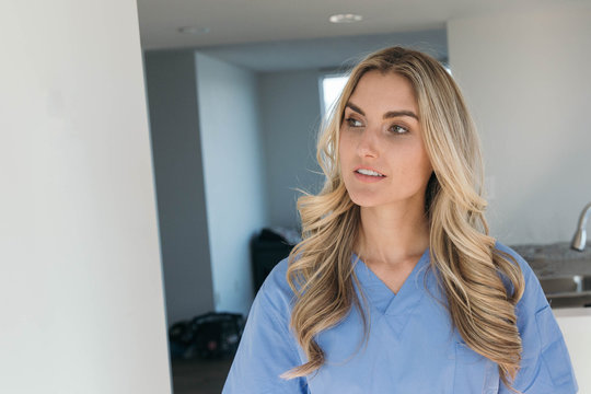 Nurse In Blue Scrubs Looking Sideways