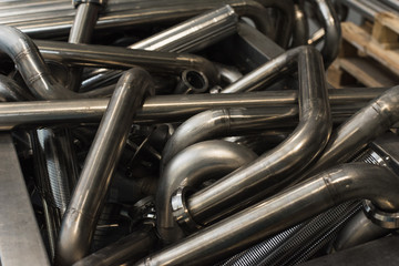 Many seamless metal curved pipes in the factory.