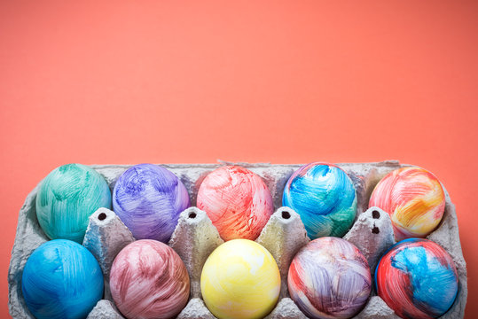 Easter eggs on a Living Coral background. 2019. Easter ideas. Easter eggs. Space for text. Happy easter.