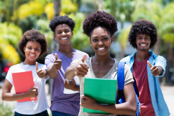 Successful african female student with group of african american students