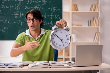 Handsome student in front of chalkboard with formulas 