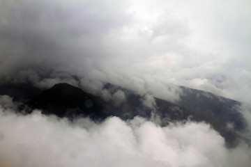 A wet day for the misty rocky mountains covered in snow and surrounded by big thick fog