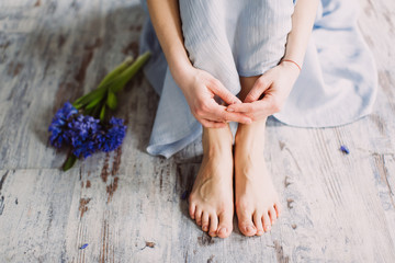 Female legs and spring flower hyacinth