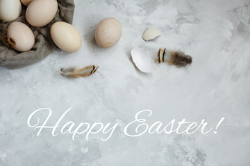 Easter eggs in a canvas bag on a gray background.