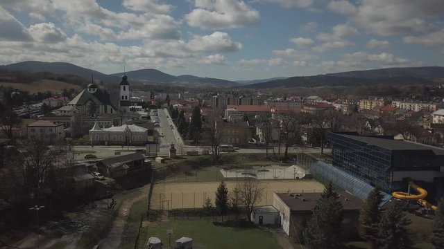 Gorlice, Poland - 3 9 2019: Panorama of the historic center of the European medieval city on the picturesque green hills. Trips to architectural monuments, temples, quarters and sports complex MOSiR
