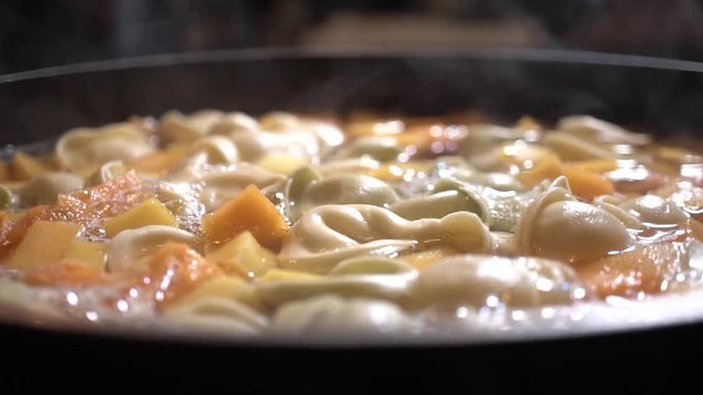 Tortellini and Butternut Squash in steaming water pot, Close Up Slider Right