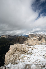 Viewing from Sass Pordoi to Piz Ciavazes and covered by the Clouds the majestic Langkofel, Sassolungo.