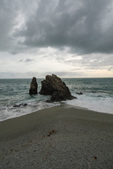 Fototapeta na wymiar Rock resisting the waves in Monterosso al Mare italy, Vertical