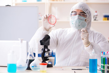 Young handsome chemist working in the lab 