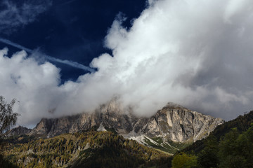 The Sassongher covered in clouds situated in the heart of the Dolomites, The dramatic Light underlines the Beauty of this Mountain in the Puez-Geisler Nature Park