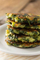 Fried vegetarian broccoli and spinach fritties, for burgers on a wooden table. Vegetarian and healthy food.