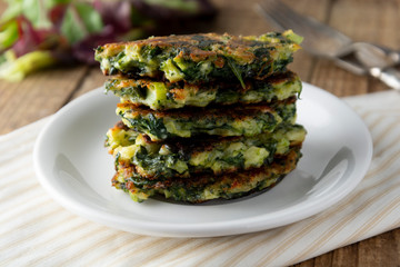 Fried vegetarian broccoli and spinach fritties, for burgers on a wooden table. Vegetarian and healthy food.