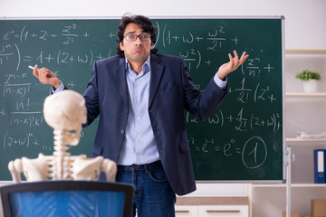 Young male math teacher and student skeleton 