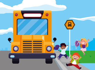 happy little interracial school kids in the bus stop
