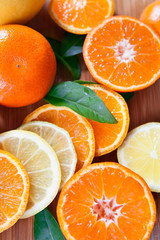 Citrus - satsuma, tangerine, orange Lemon, lime, mandarin and fresh slices. Wooden background, flat lay, top view position.