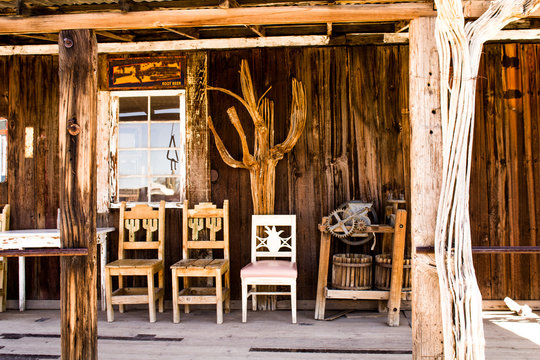 Three Wooden Chairs on the Front Porch of an Old Time Store